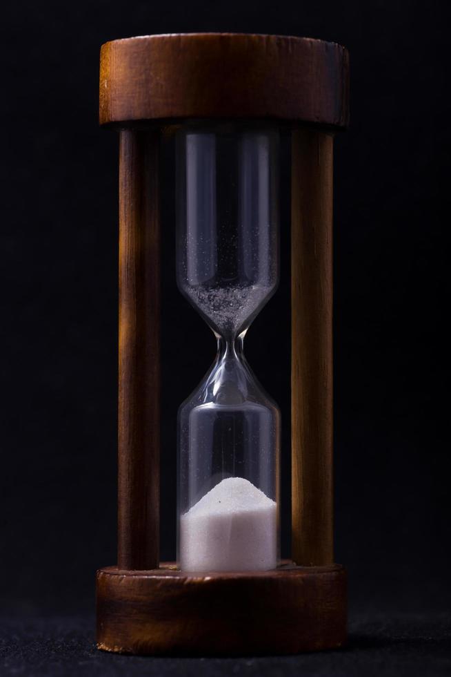 sand falling in hour glass photo