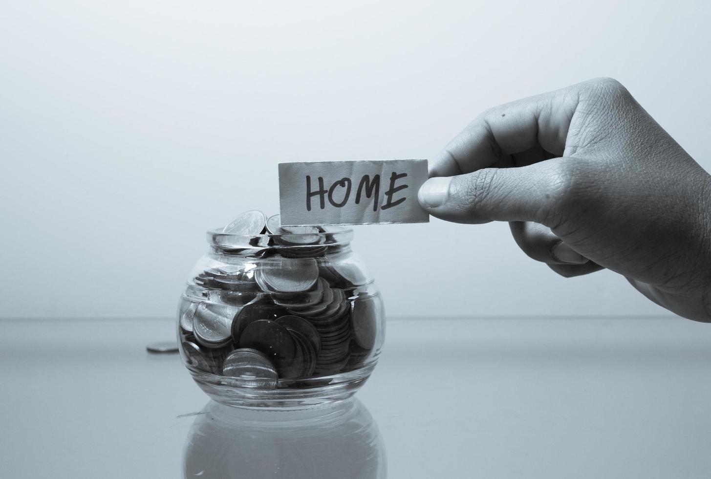 Money jar with coins  Saving for House Concept photo