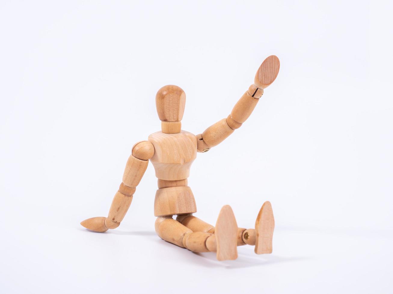 The wooden dummy sits on white background photo