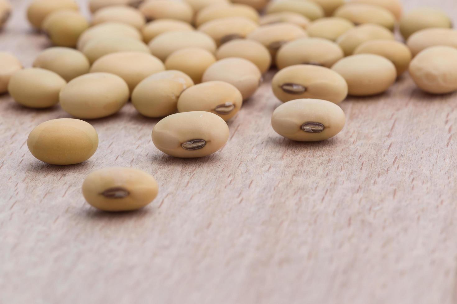 Soy beans on wood background photo