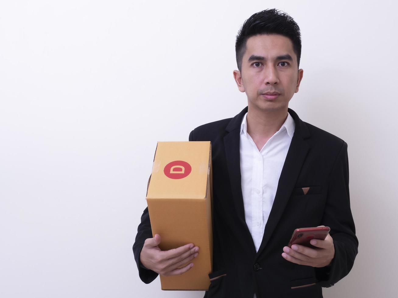 Shipper young Asian man holding cardboard box photo