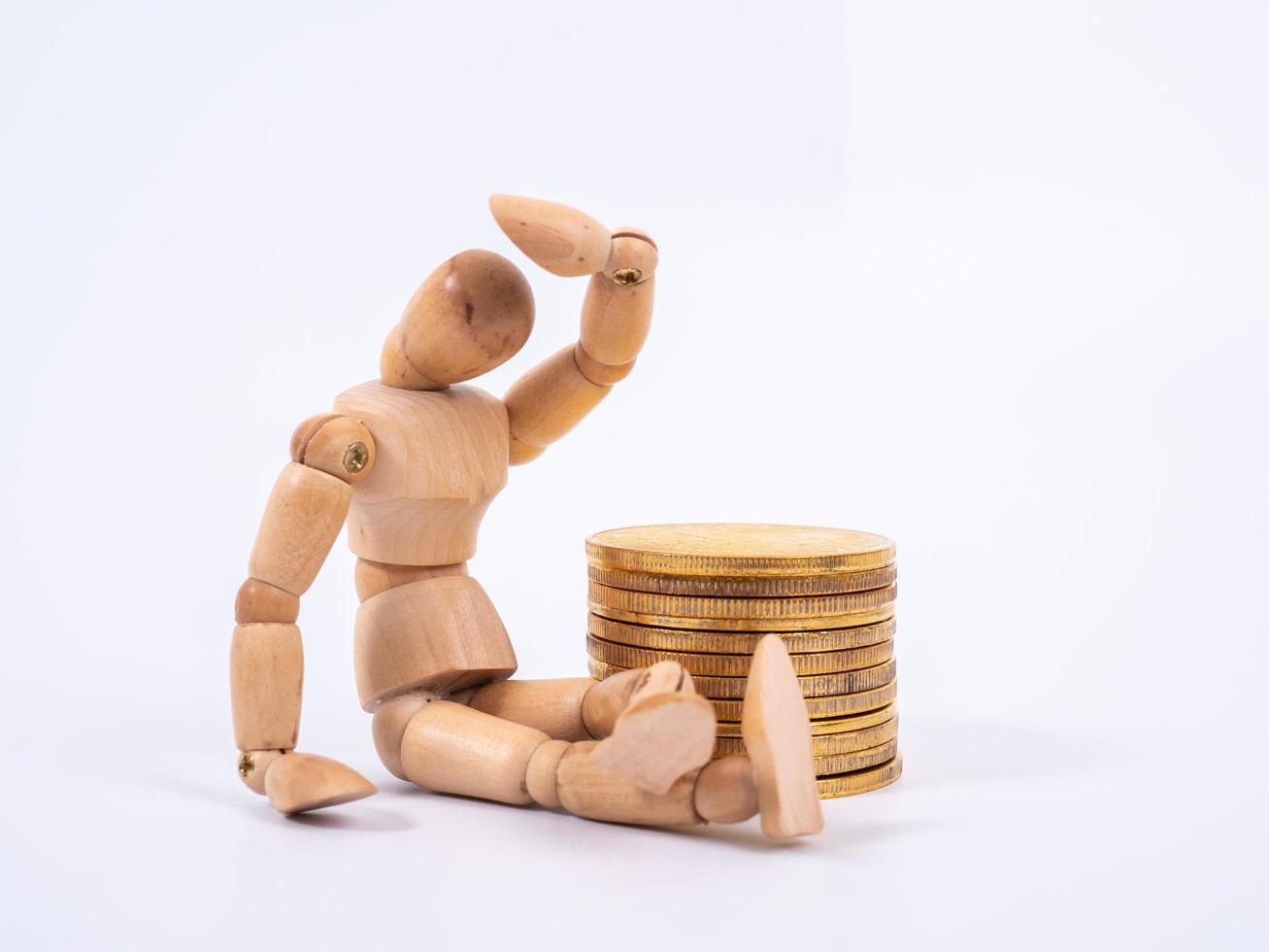 Wooden puppet Rolls of coins for finance and business concept photo