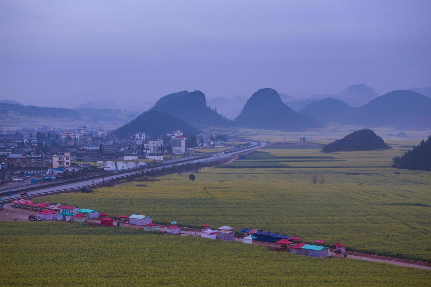 Yellow rapeseed flower field with the mist in Luoping, China photo