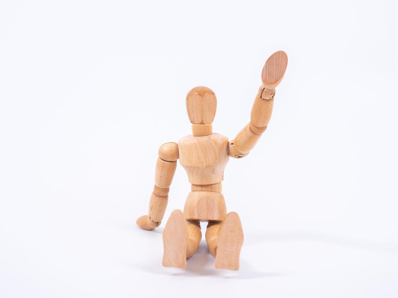 The wooden dummy sits on white background photo