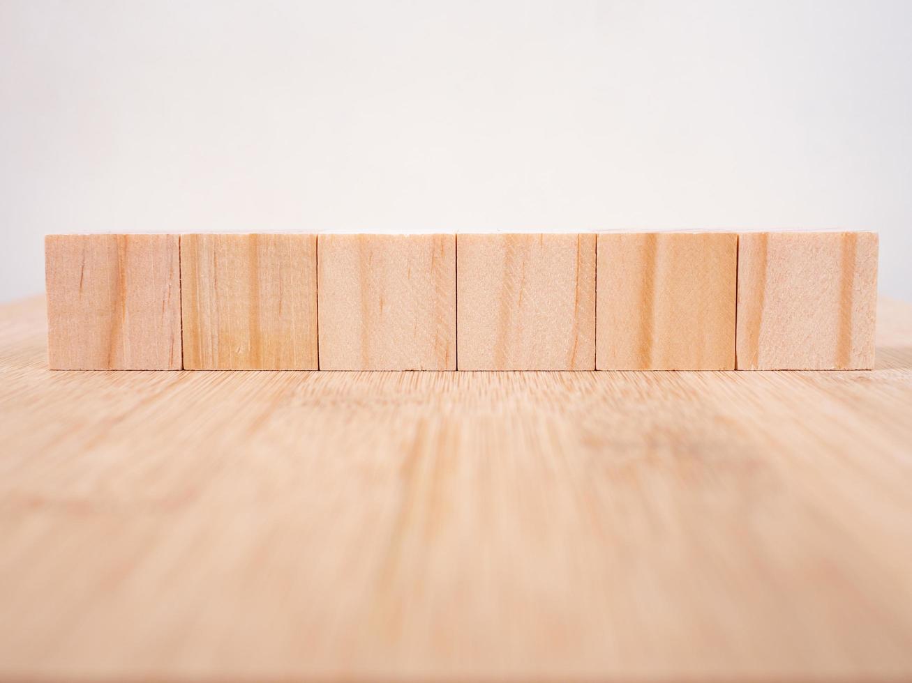 Wooden floor with empty wooden cubes as a template for words photo