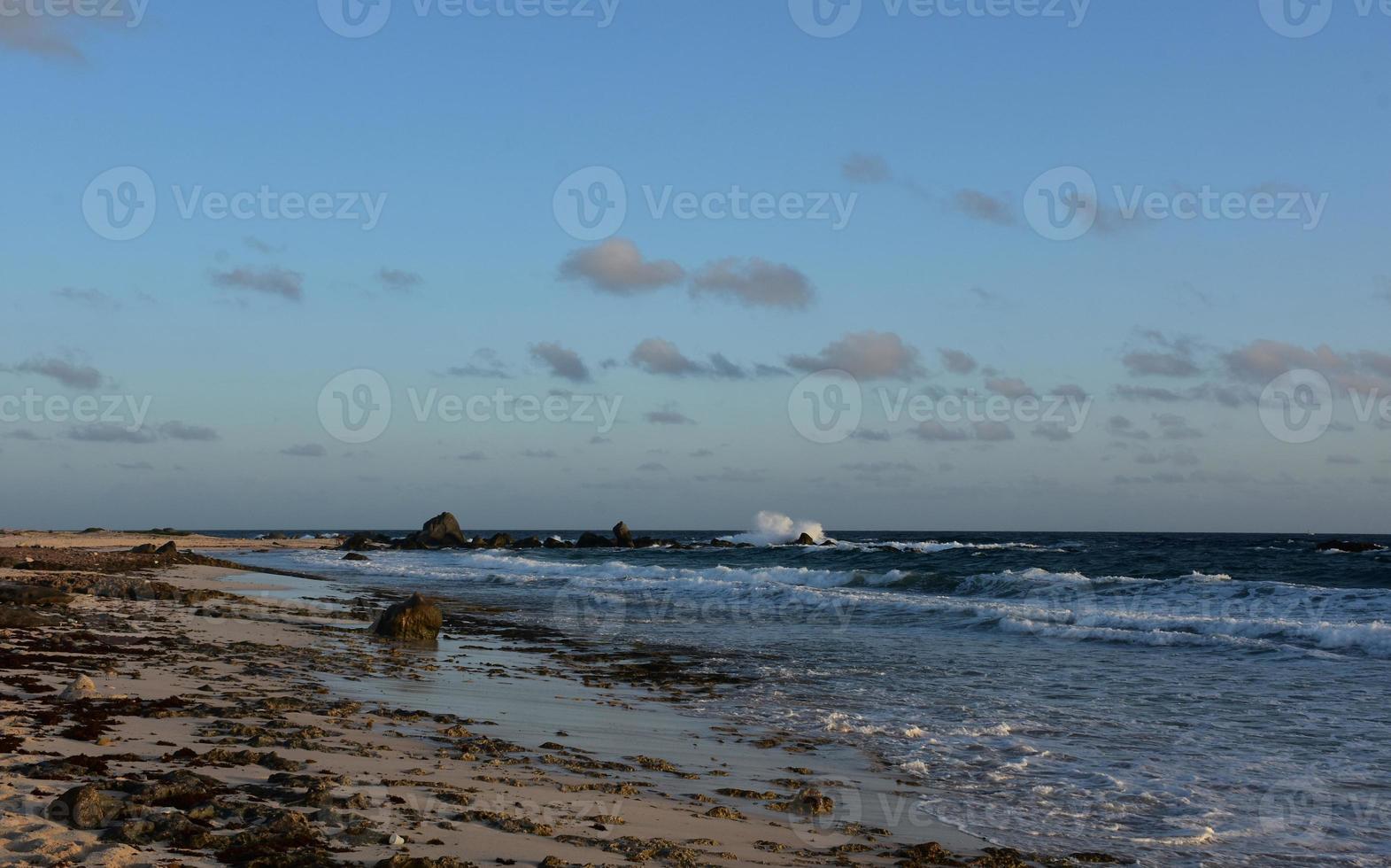 Gorgeous Scenic Beach with Waves Crashing on Rocks photo