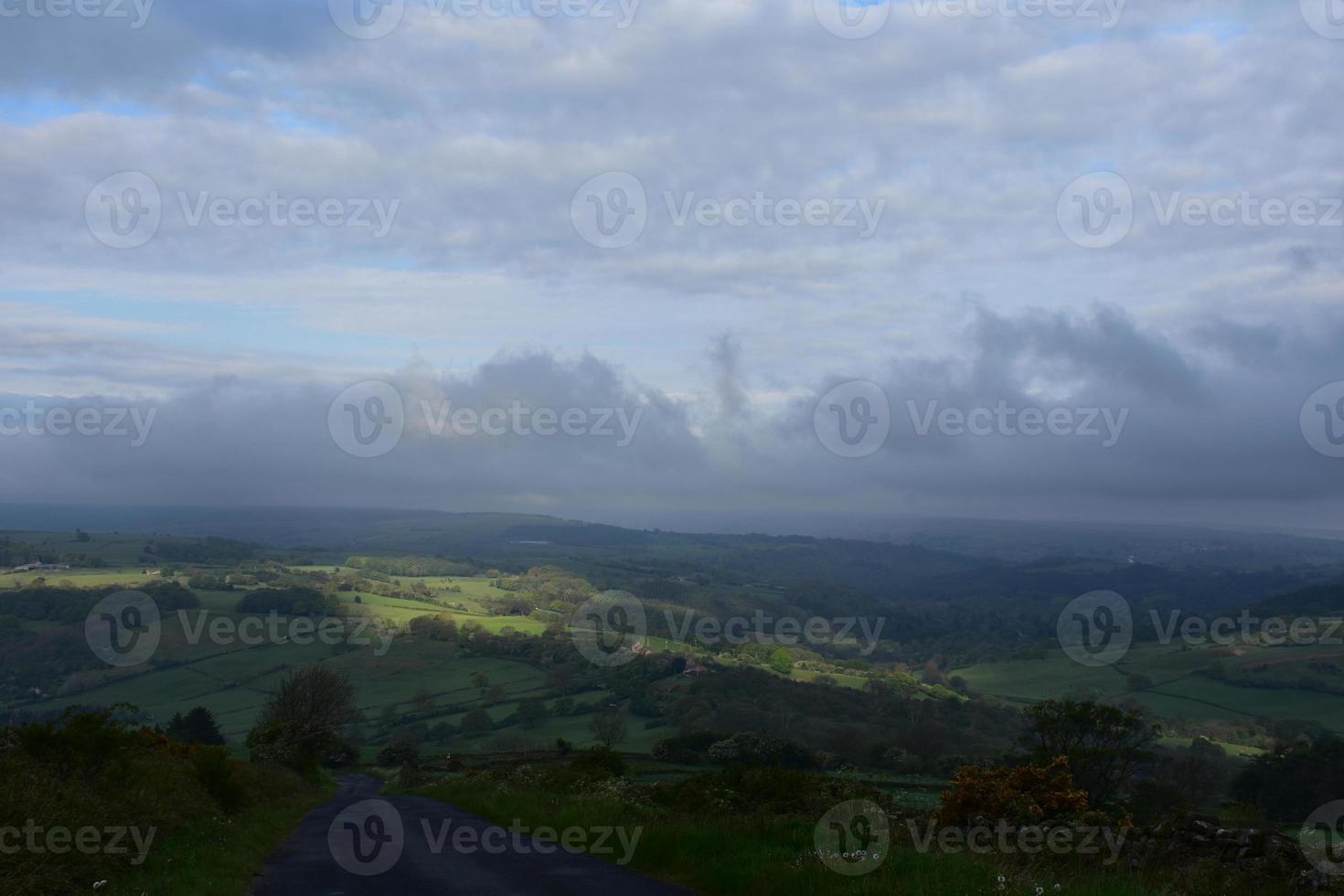 Spots of Sunshine Breaking Through Thick Cloud Cover photo
