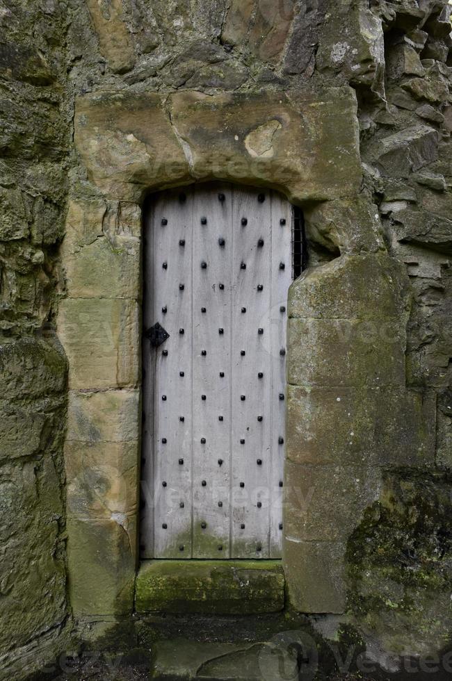 Studded Wooden Door in Stone Remains and Ruins photo