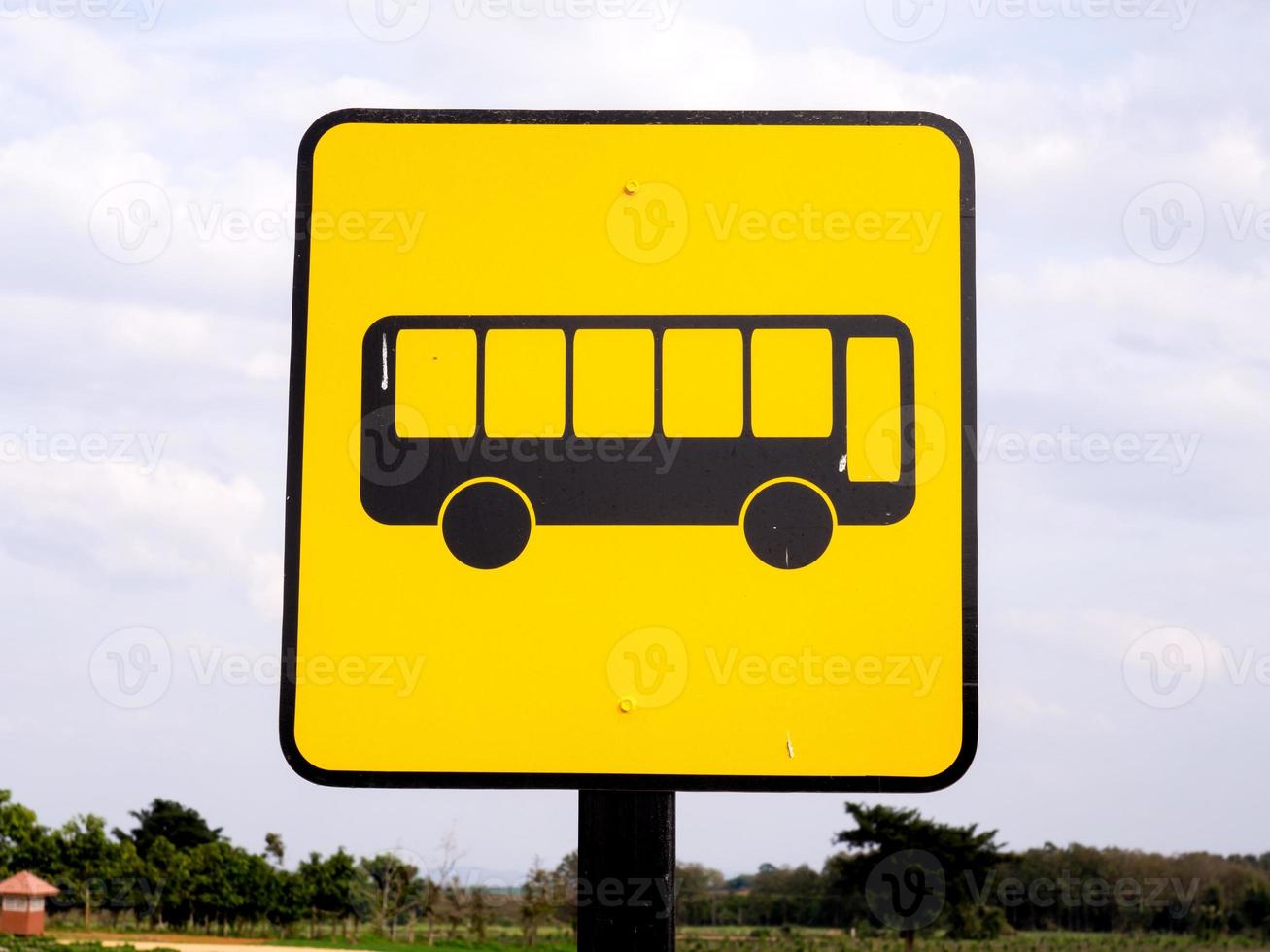 Bus stop sign in rural road photo