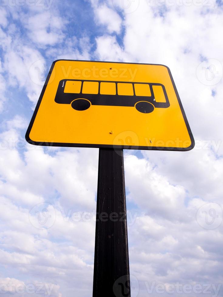 Bus stop sign in rural road photo