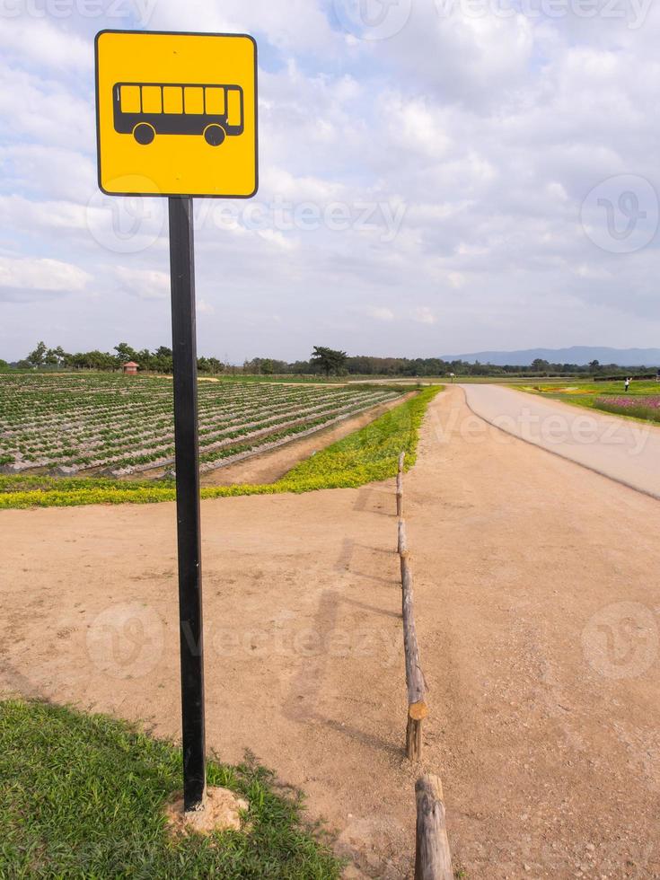 Bus stop sign in rural road photo