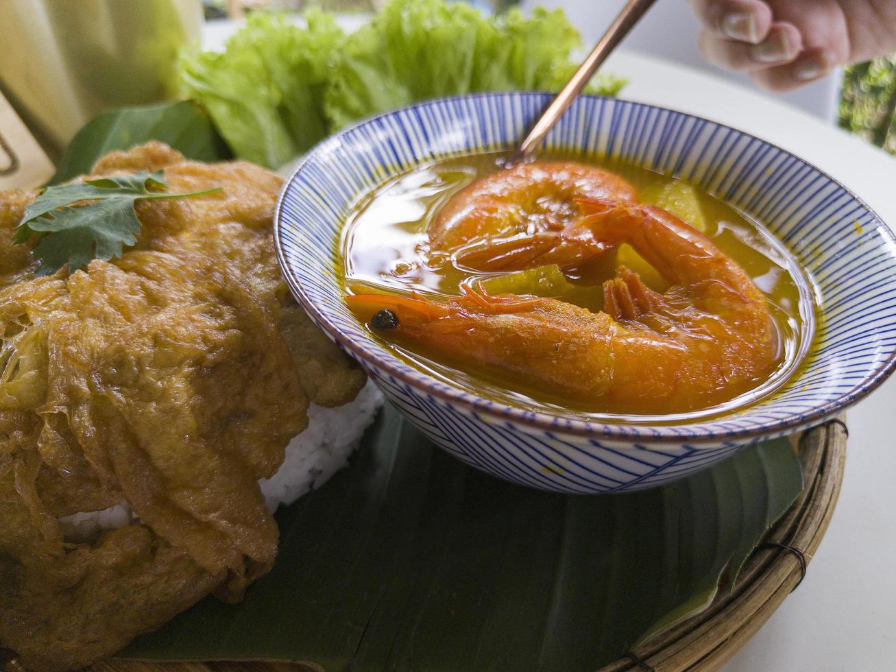 Close up Hot and spicy soup with papaya and Shrimp in bowl.Thai traditional healthy menu and diet food. Selected focus photo