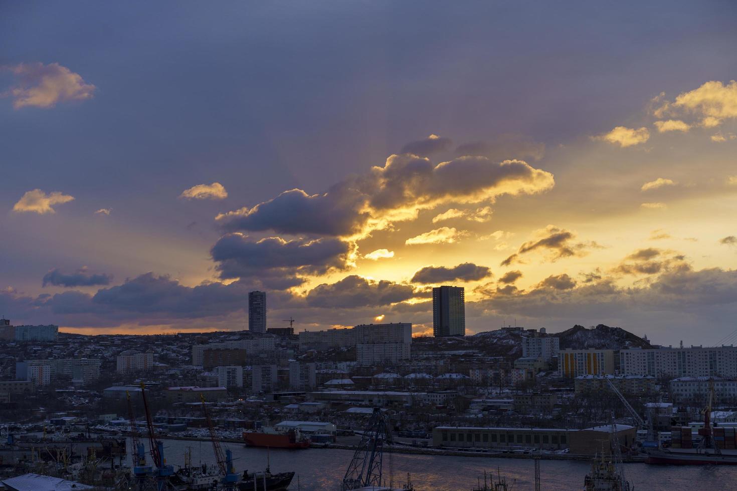 A cityscape at dawn with the rays of the sun. Vladivostok, Russia photo