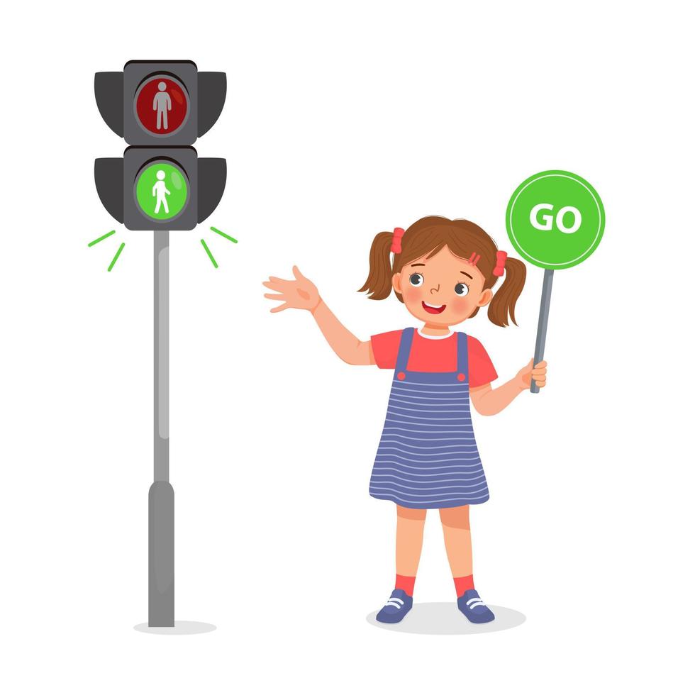 linda niña sosteniendo un cartel de ir cerca del semáforo peatonal con luz indicadora verde encendida vector
