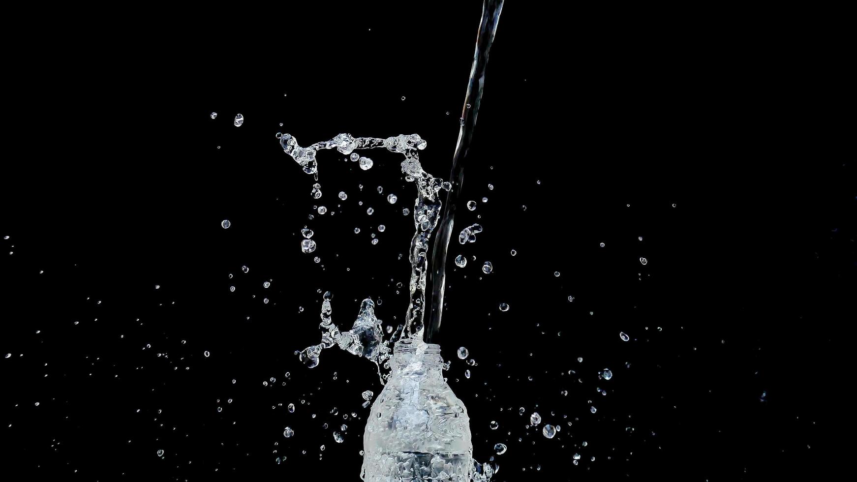 Abstract water jet crashes on a black background photo