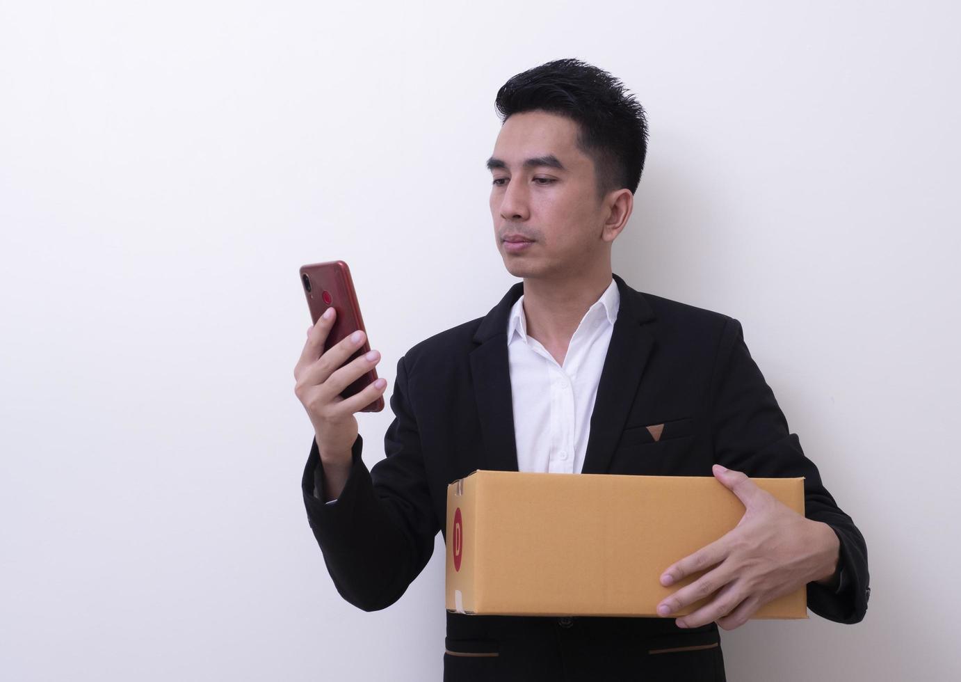 Shipper young Asian man holding cardboard box photo