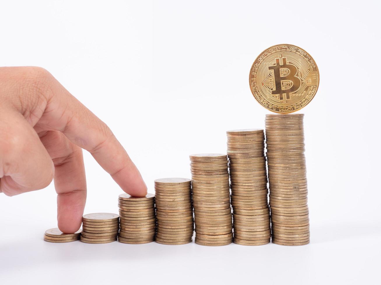 Man's hand put money coins to stack of  cryptocurrency. Money, Financial, Business Growth concept photo