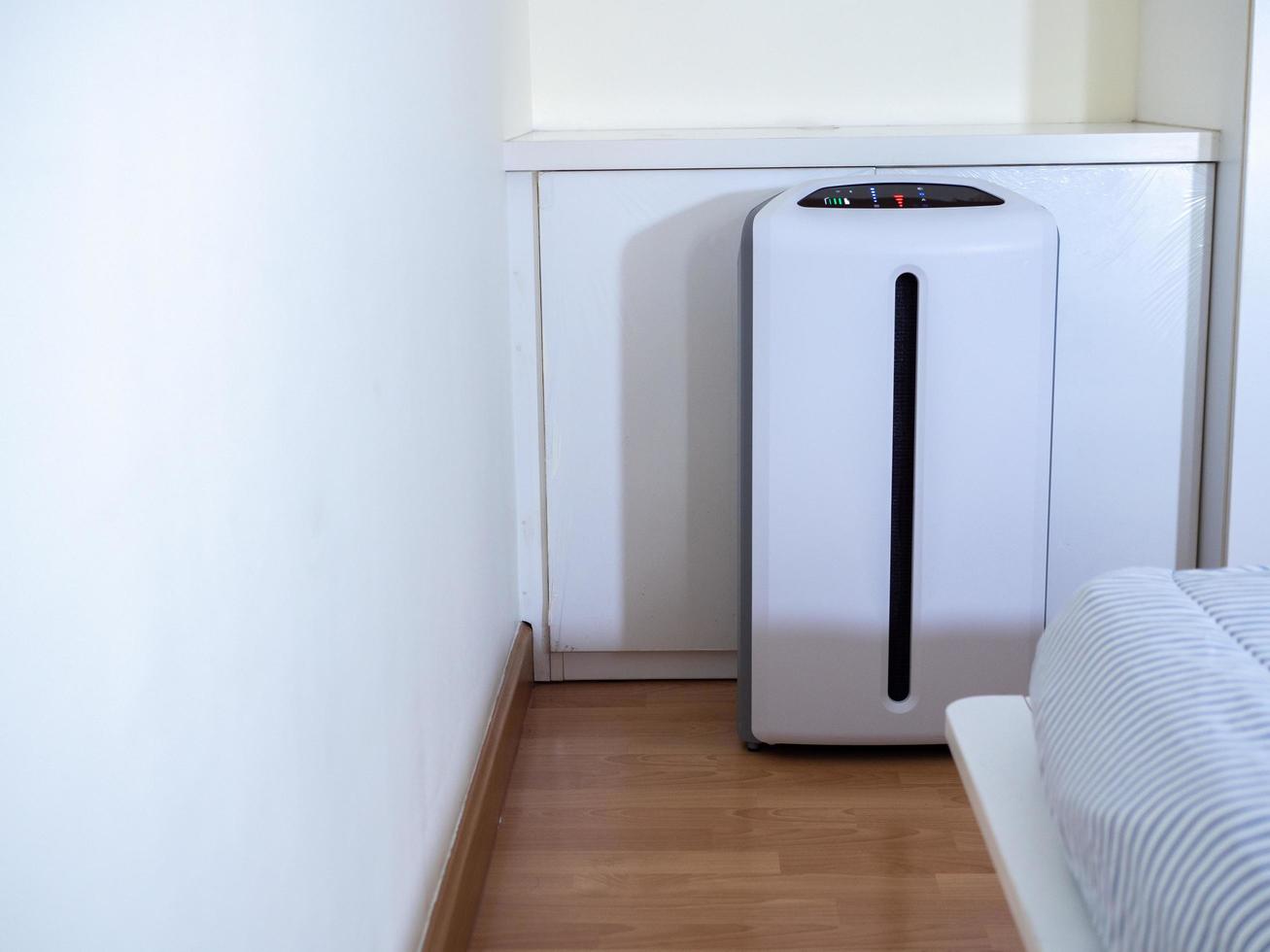 air purifier in bed room. air cleaner removing fine dust in house photo