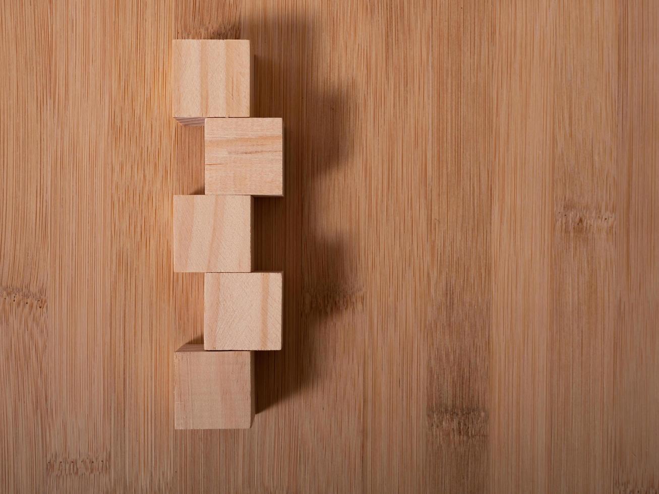Wooden floor with empty wooden cubes as a template for words photo