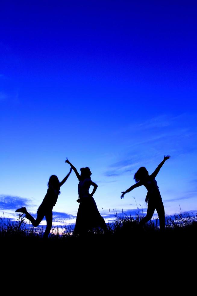 Happy woman   and sunset silhouette photo