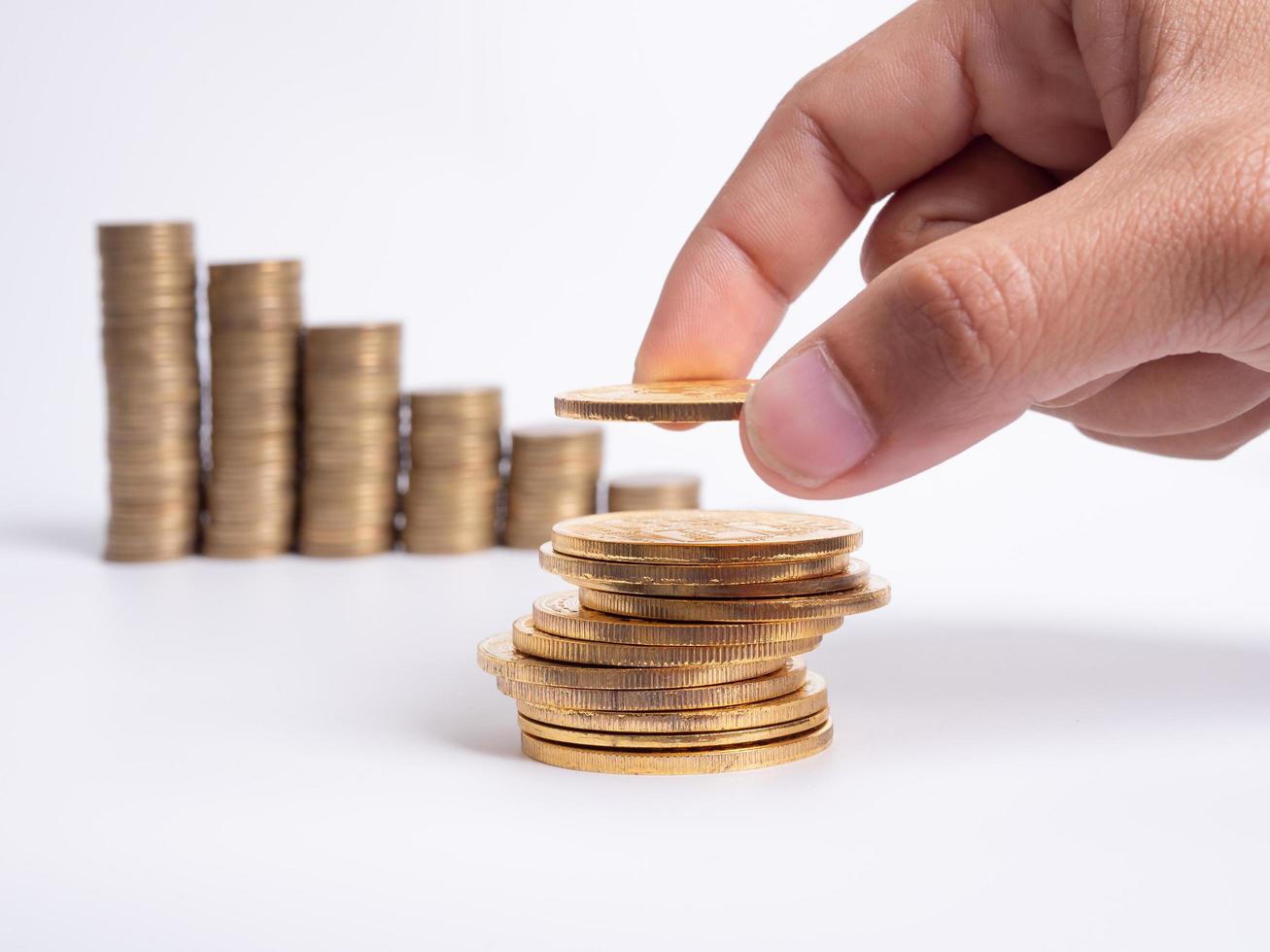 Man's hand put money coins to stack of  cryptocurrency. Money, Financial, Business Growth concept photo