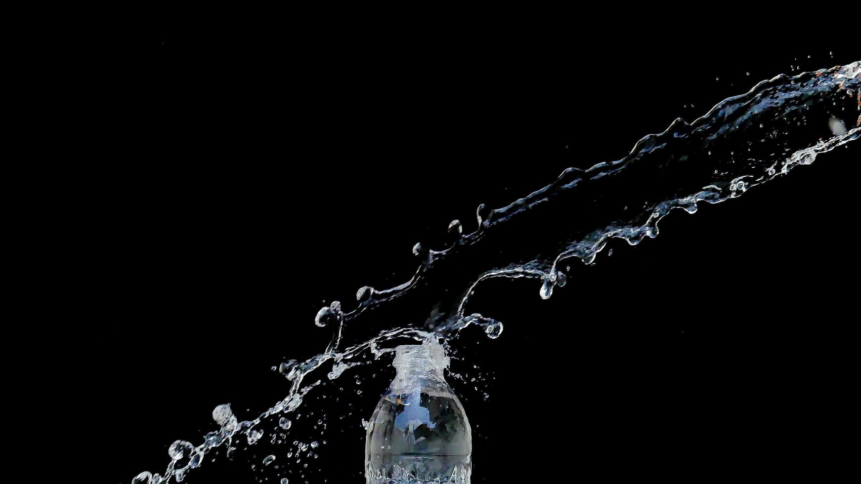 Abstract water jet crashes on a black background photo