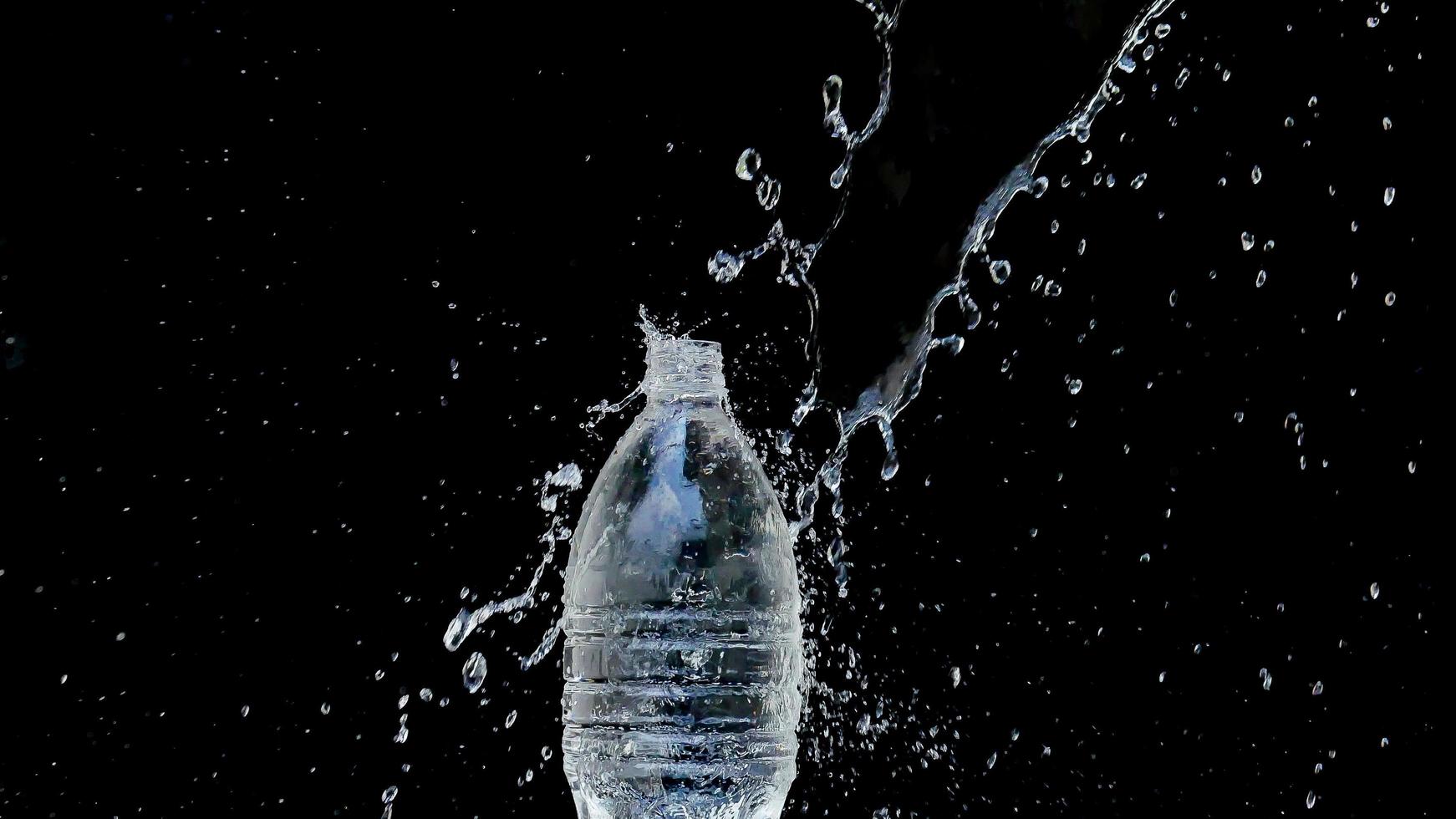 Abstract water jet crashes on a black background photo