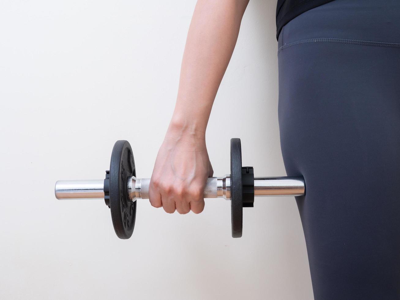 hand holding dumbbell isolated on white background photo