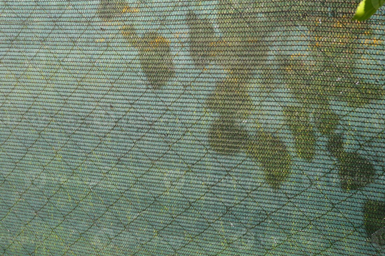 Installation of a shading net on a chain-link fence photo