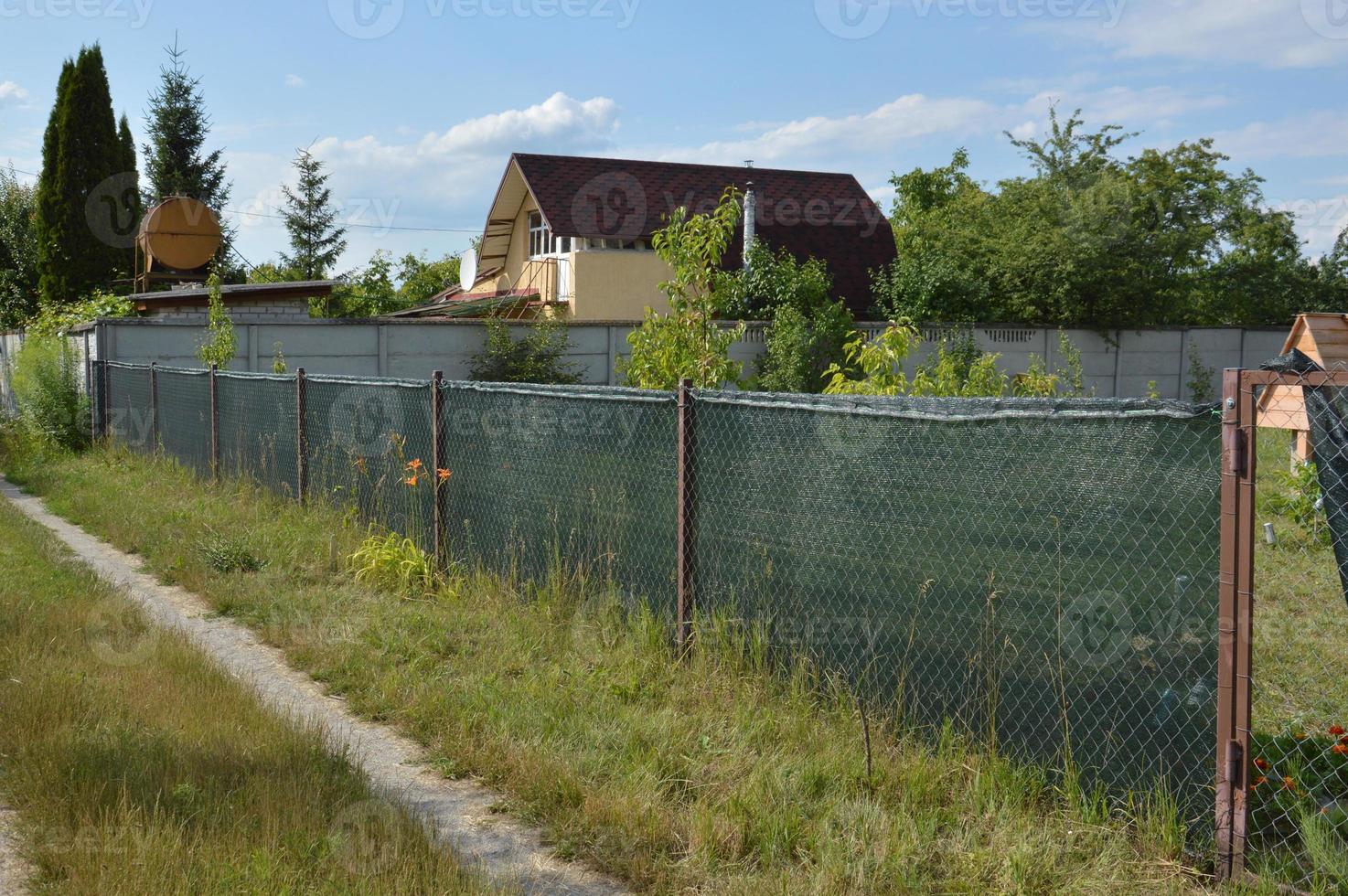 Installation of a shading net on a chain-link fence photo