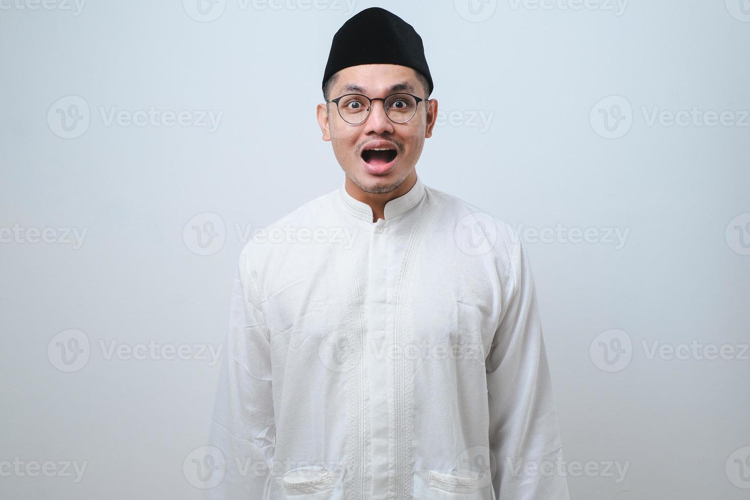 Asian muslim man shocked gesture can not believe of what he sees photo
