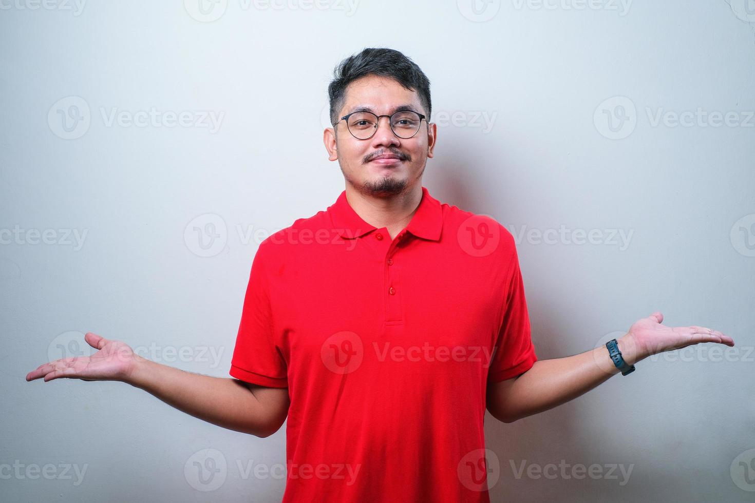 Asian man clueless and confused expression with arms and hands raised. Doubt concept. photo