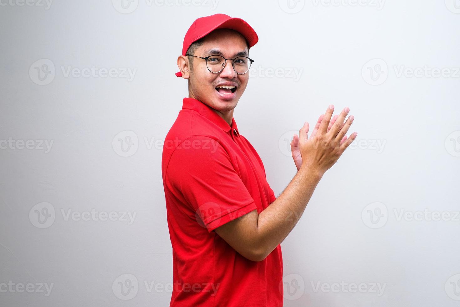 Asian delivery man clapping and applauding happy and joyful, smiling proud hands together photo