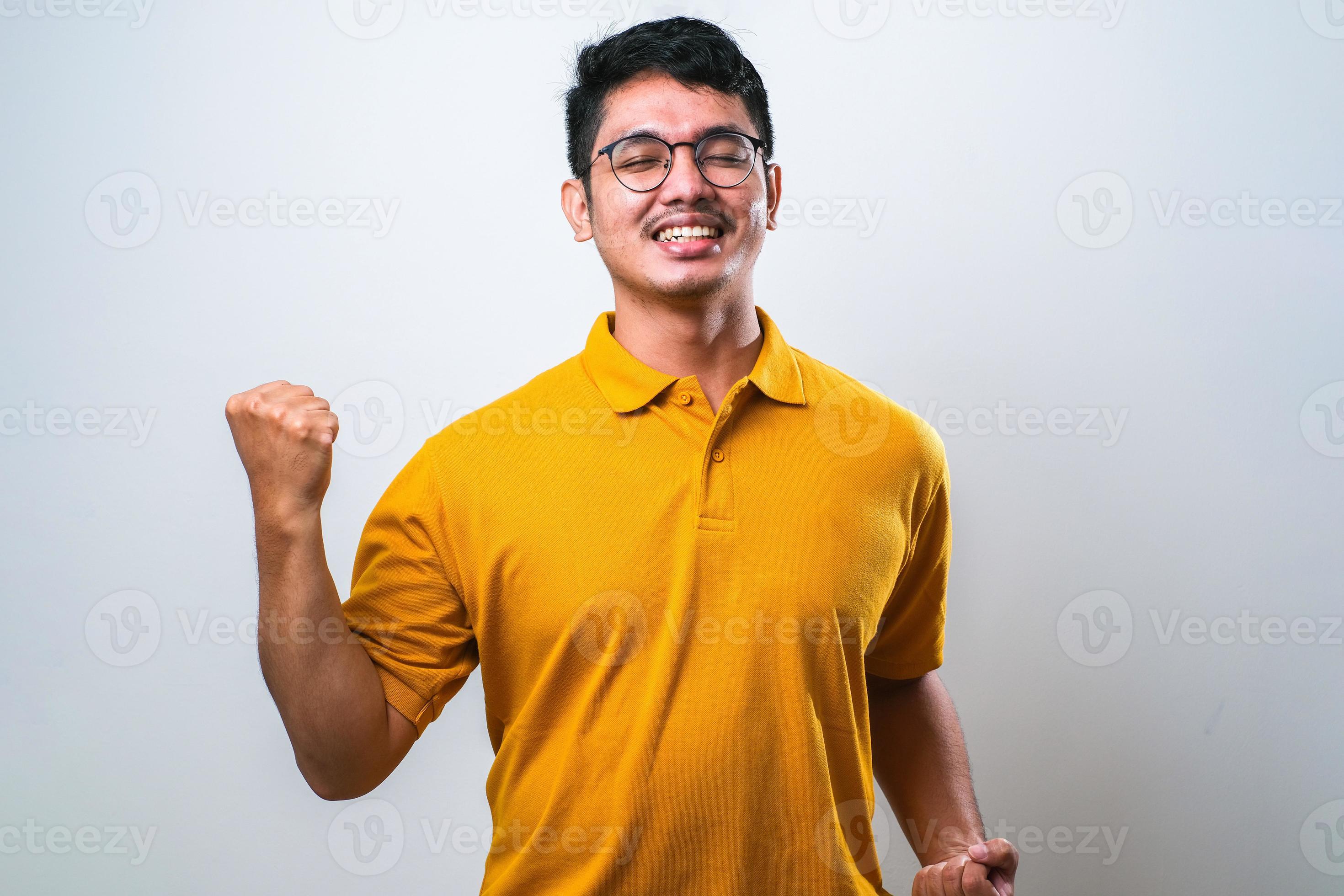 Asian man showing happy excited expression with clenched fist 9651212
