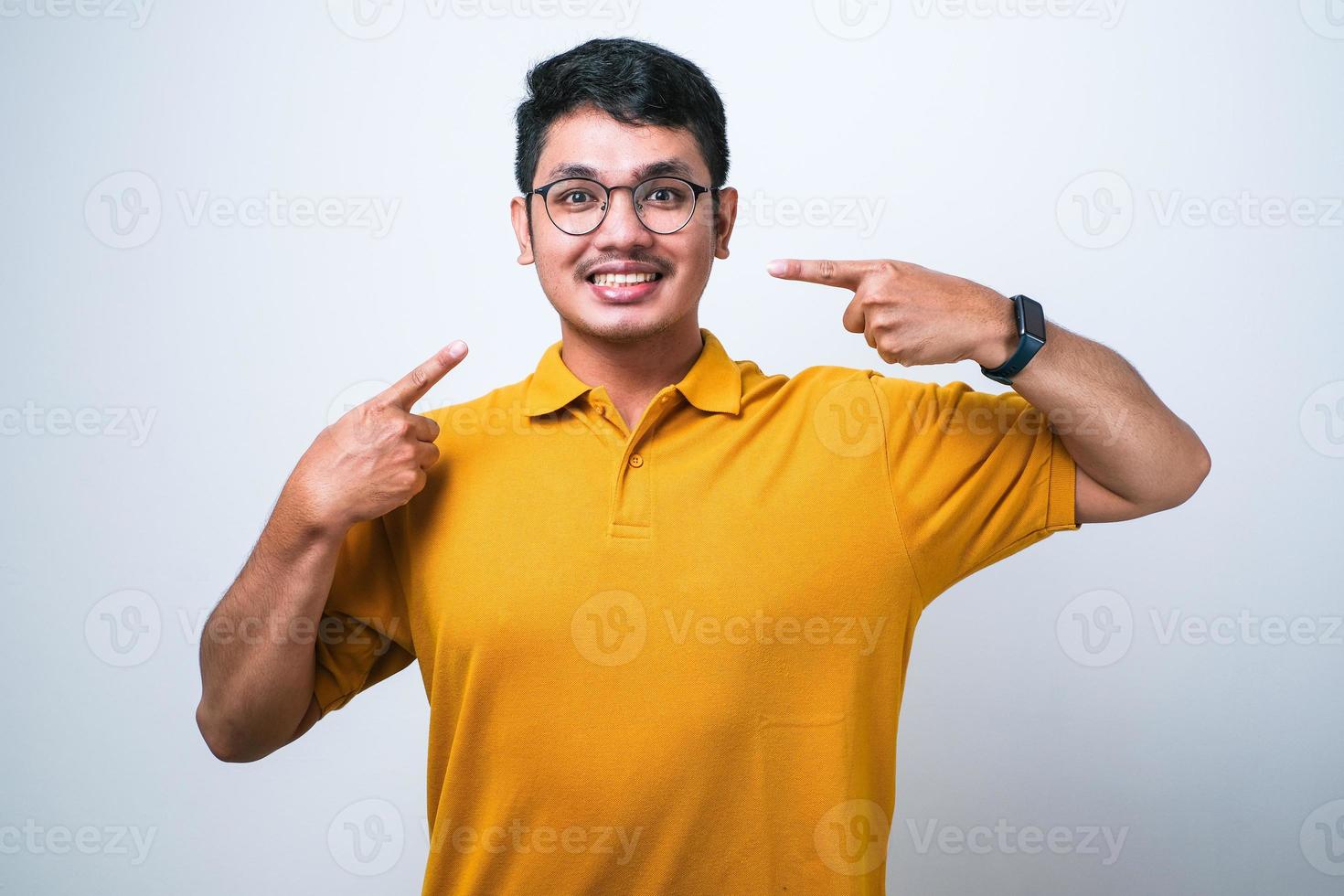 Young handsome man smiling cheerful showing and pointing with fingers teeth and mouth. Dental health concept. photo