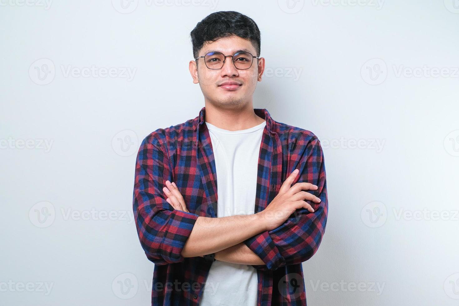 Young handsome man happy face smiling with crossed arms looking at the camera. positive person. photo