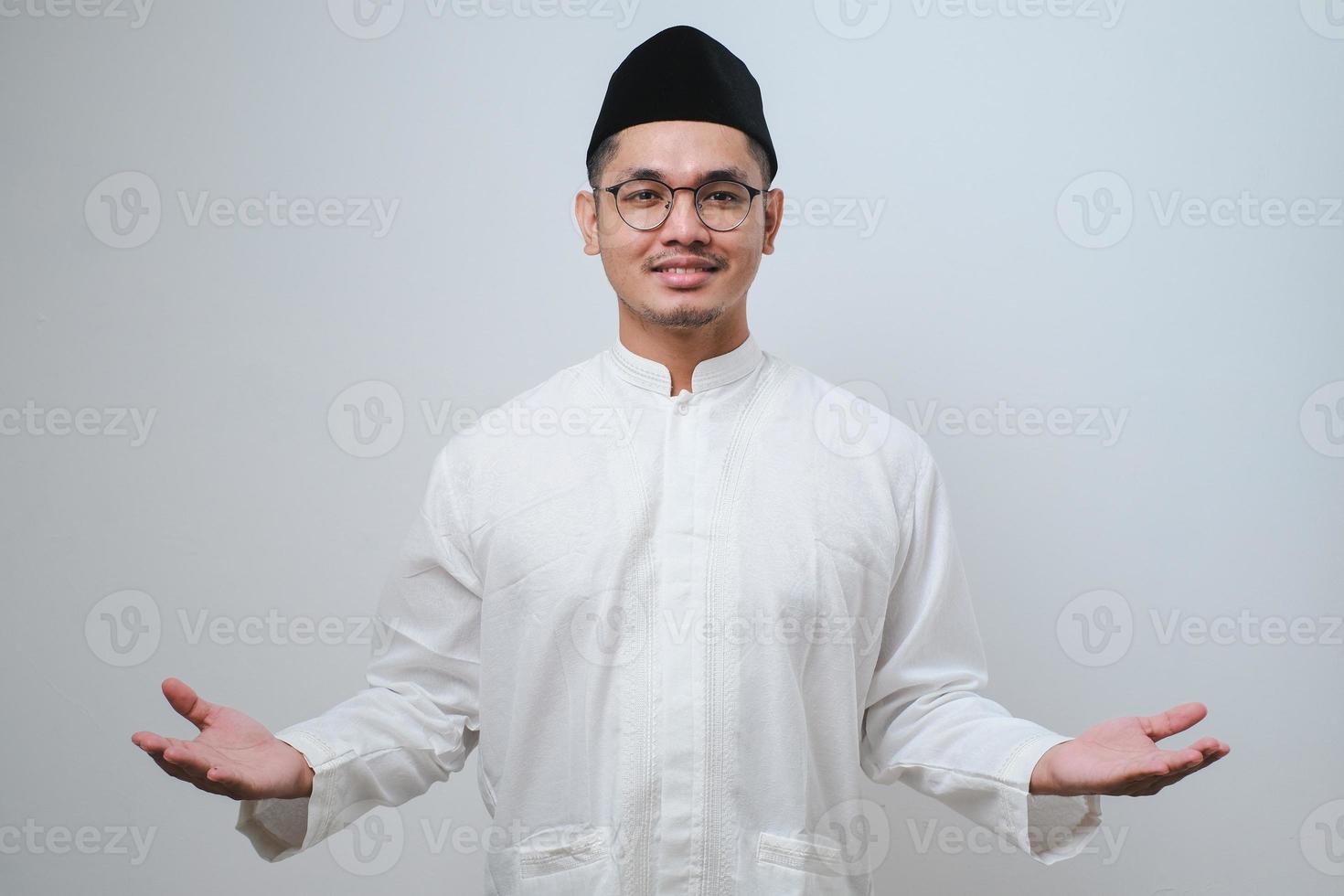 Asian man smiling happy to greeting during Ramadan celebration with both arms open photo