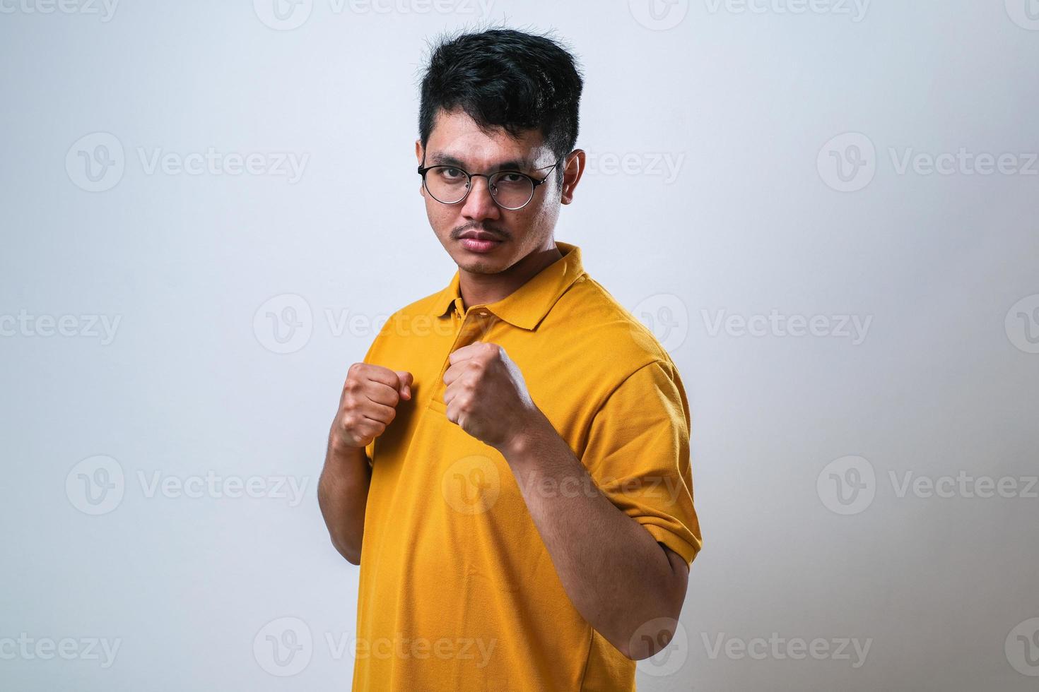 Asian man punching fist to fight, aggressive and angry attack, threat and violence photo