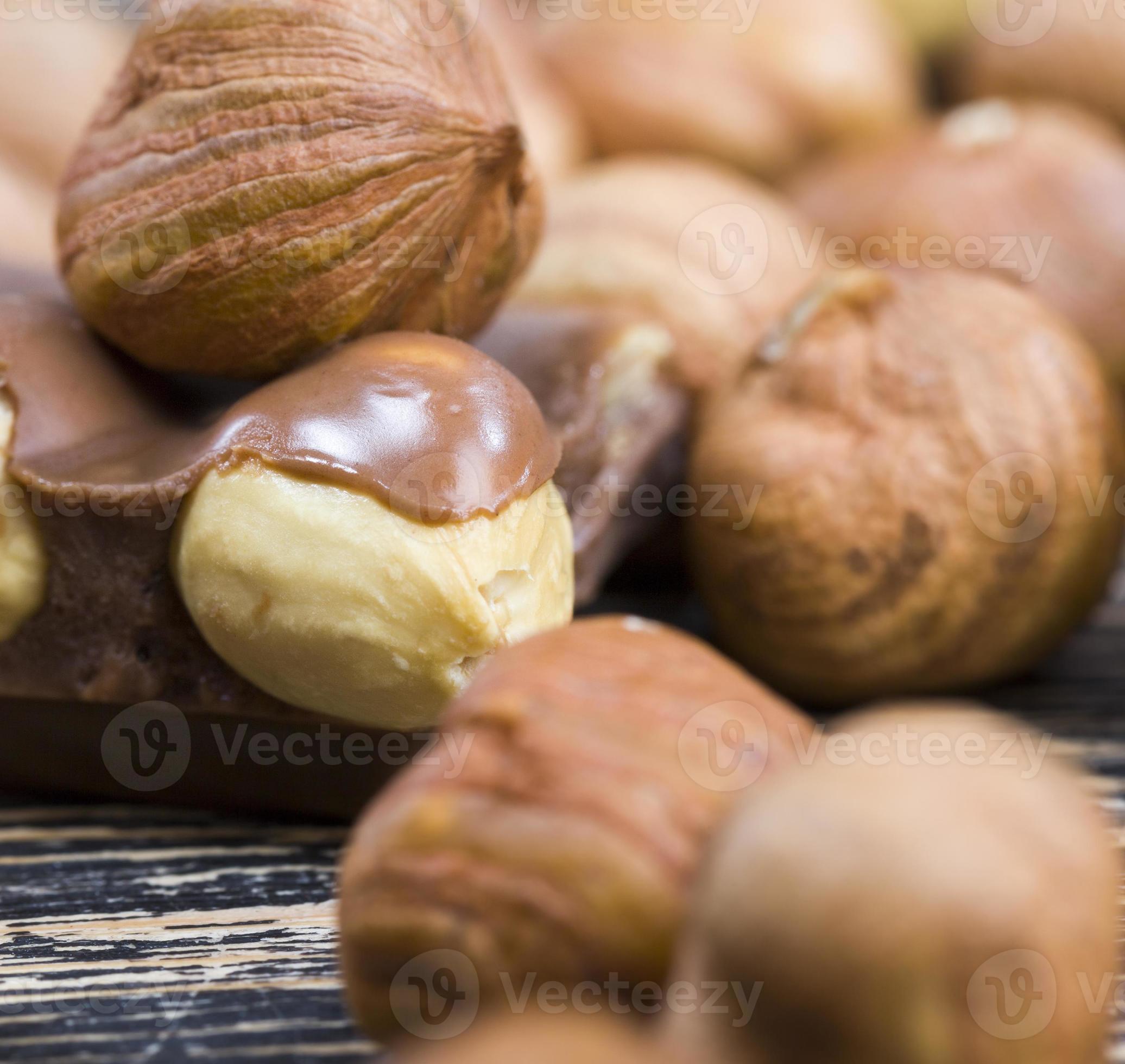 bitter real chocolate, photographed close up with whole hazelnuts