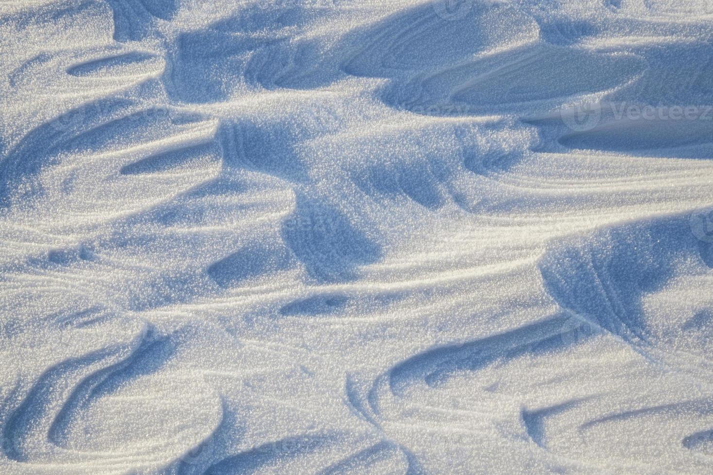 Snowdrifts in a field in winter photo