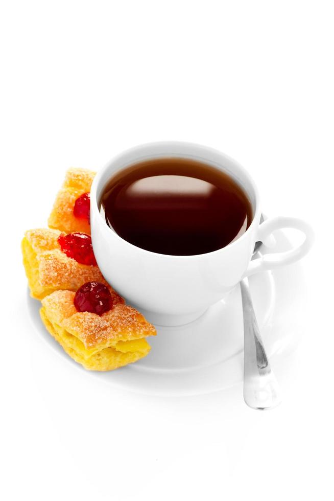 cup of tea on a saucer and cake. photo