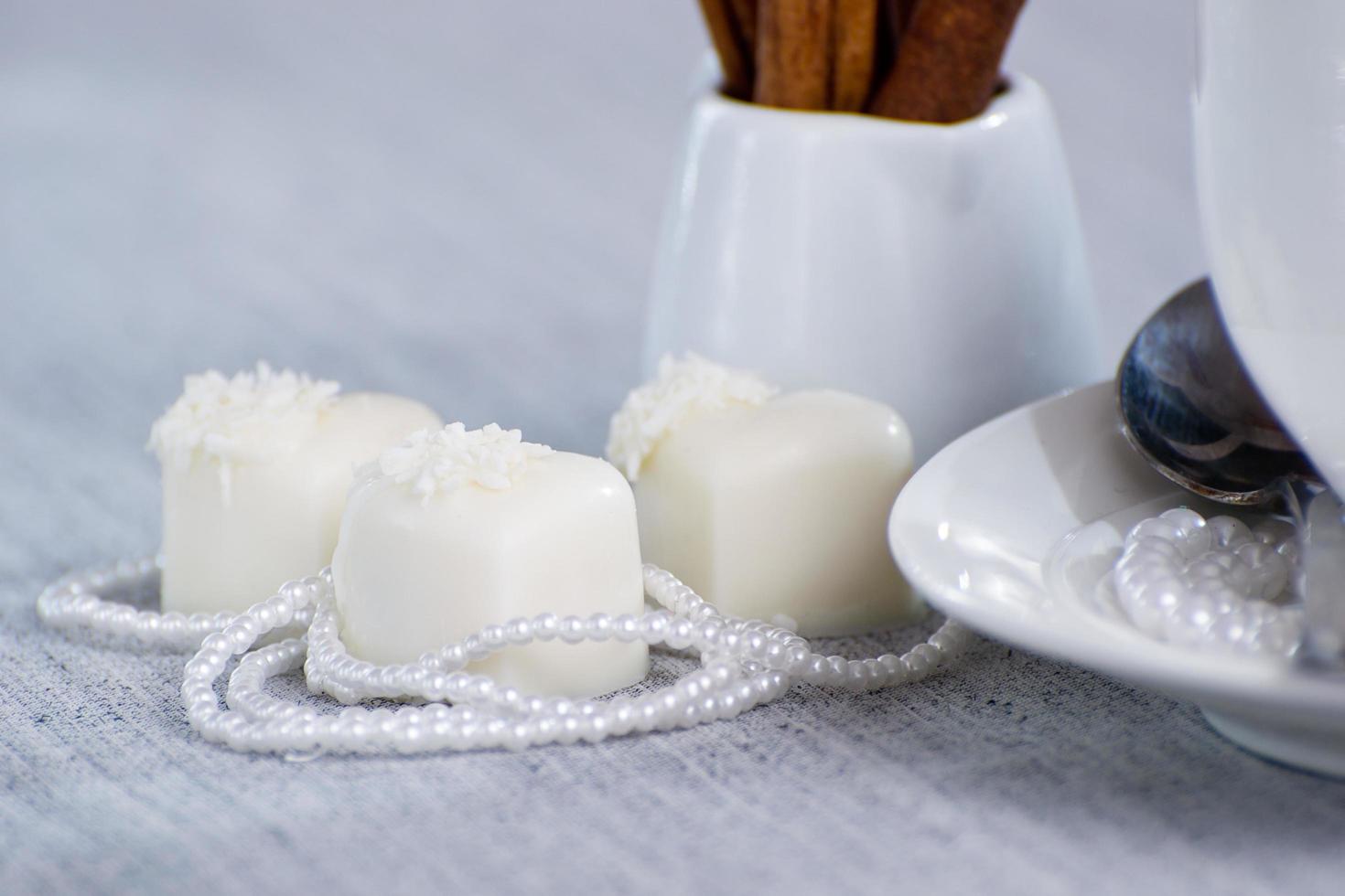 heart-shaped chocolates with candies in coconut flakes of beads photo