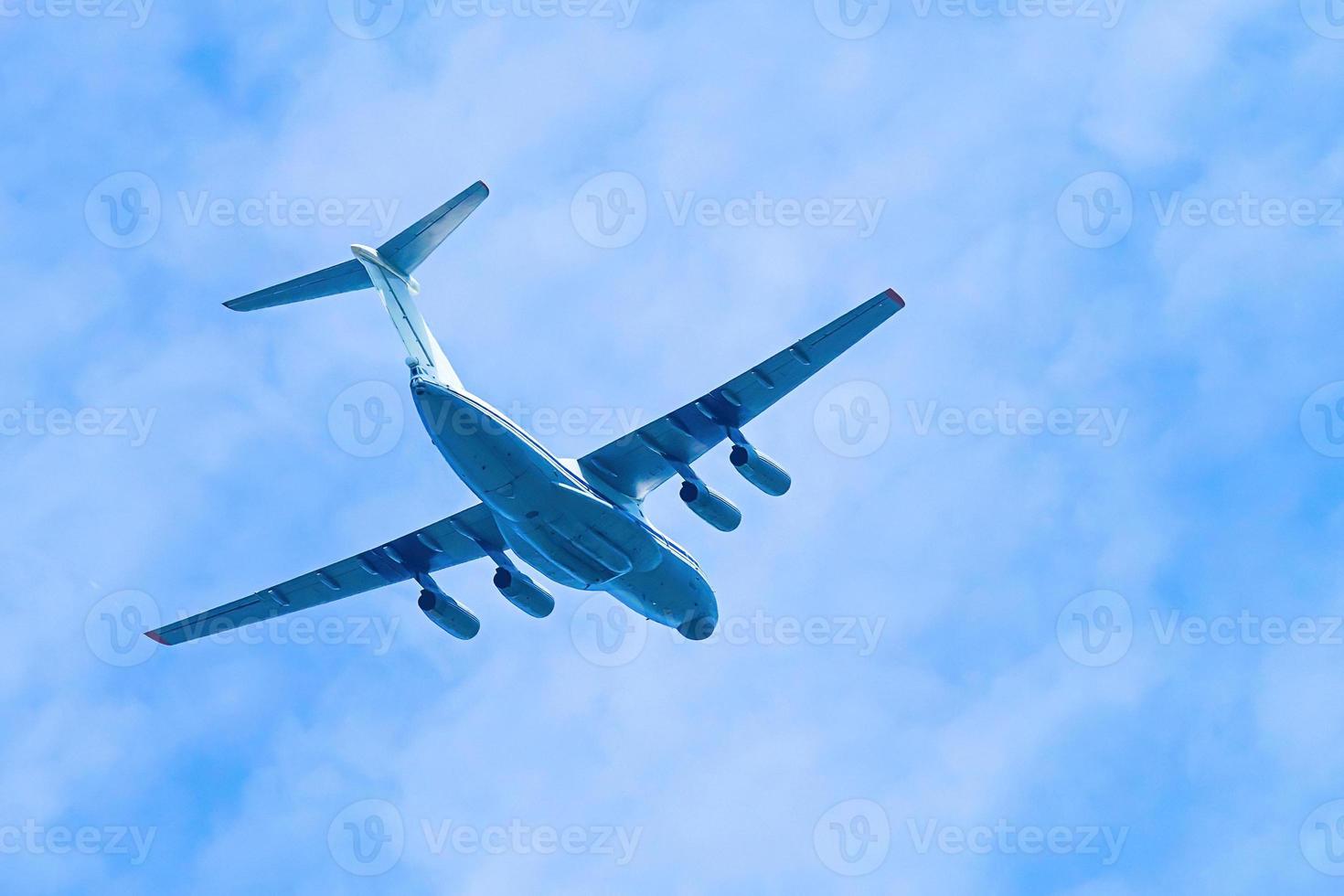 Airplane in blue sky. Air cargo transportation. Plane is flying photo