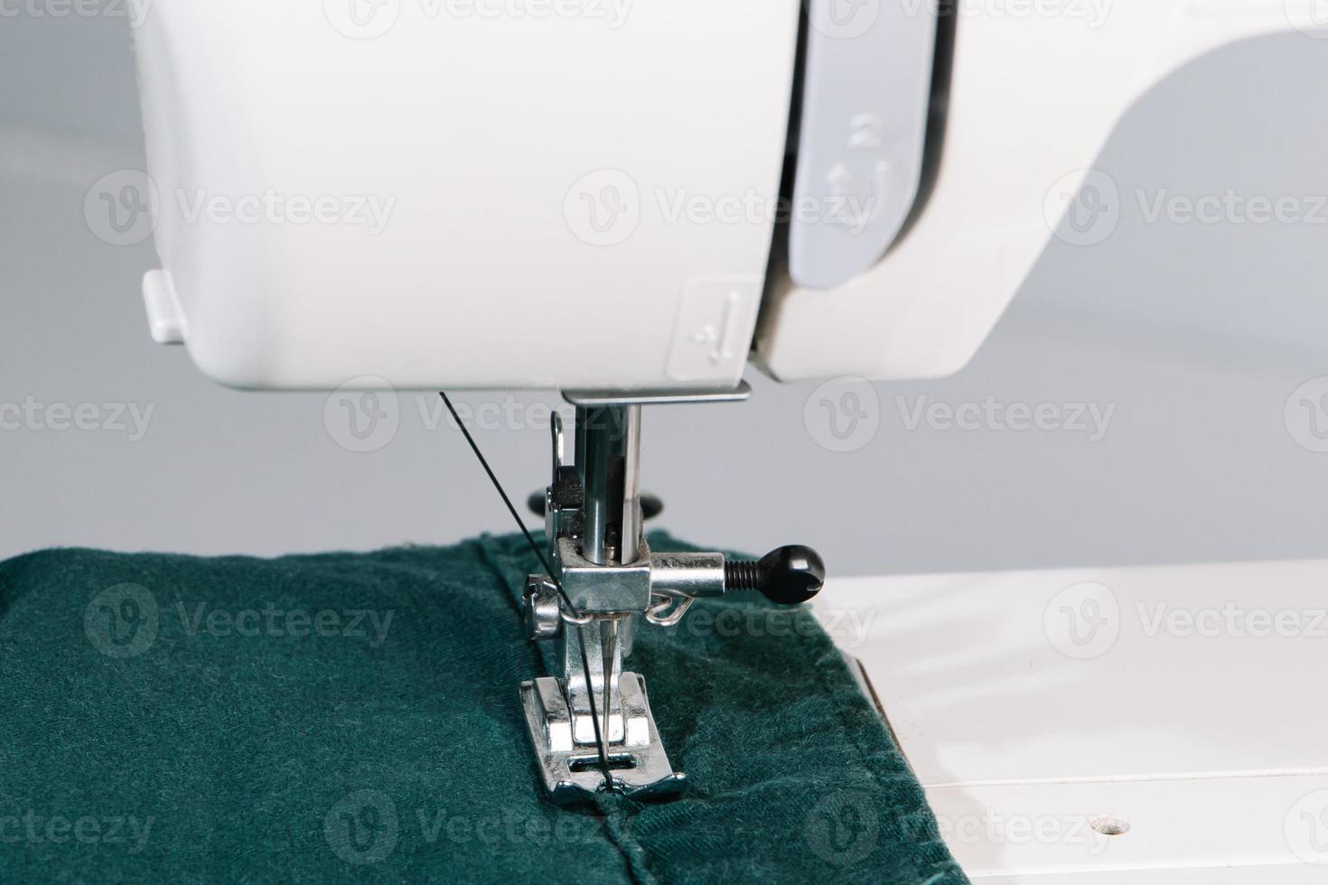 Close-up of sewing process, working on sewing machine. World tailors day. photo