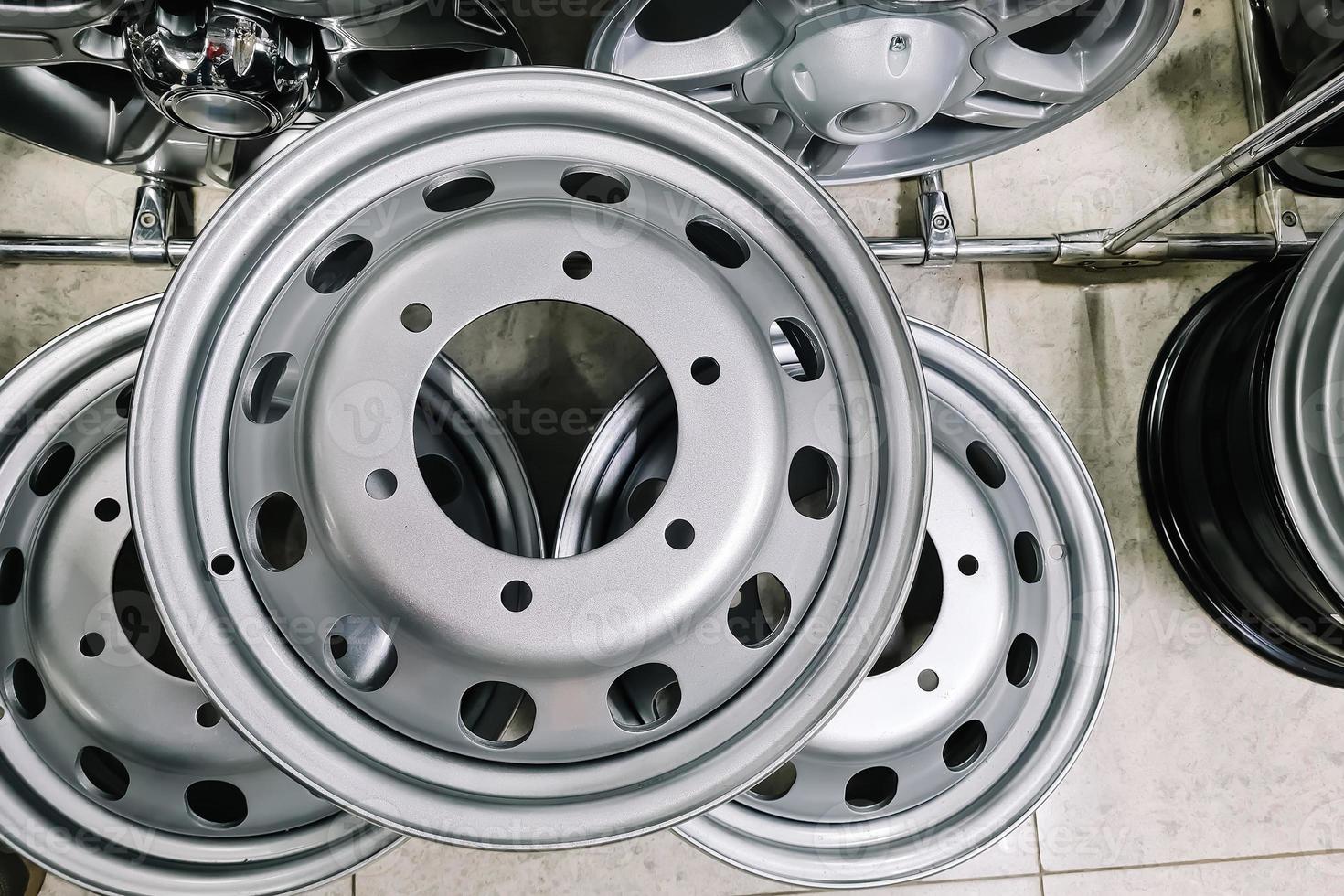 Auto shop selling car rims. Stand for sale of alloy wheels. Discounts at auto parts store. photo