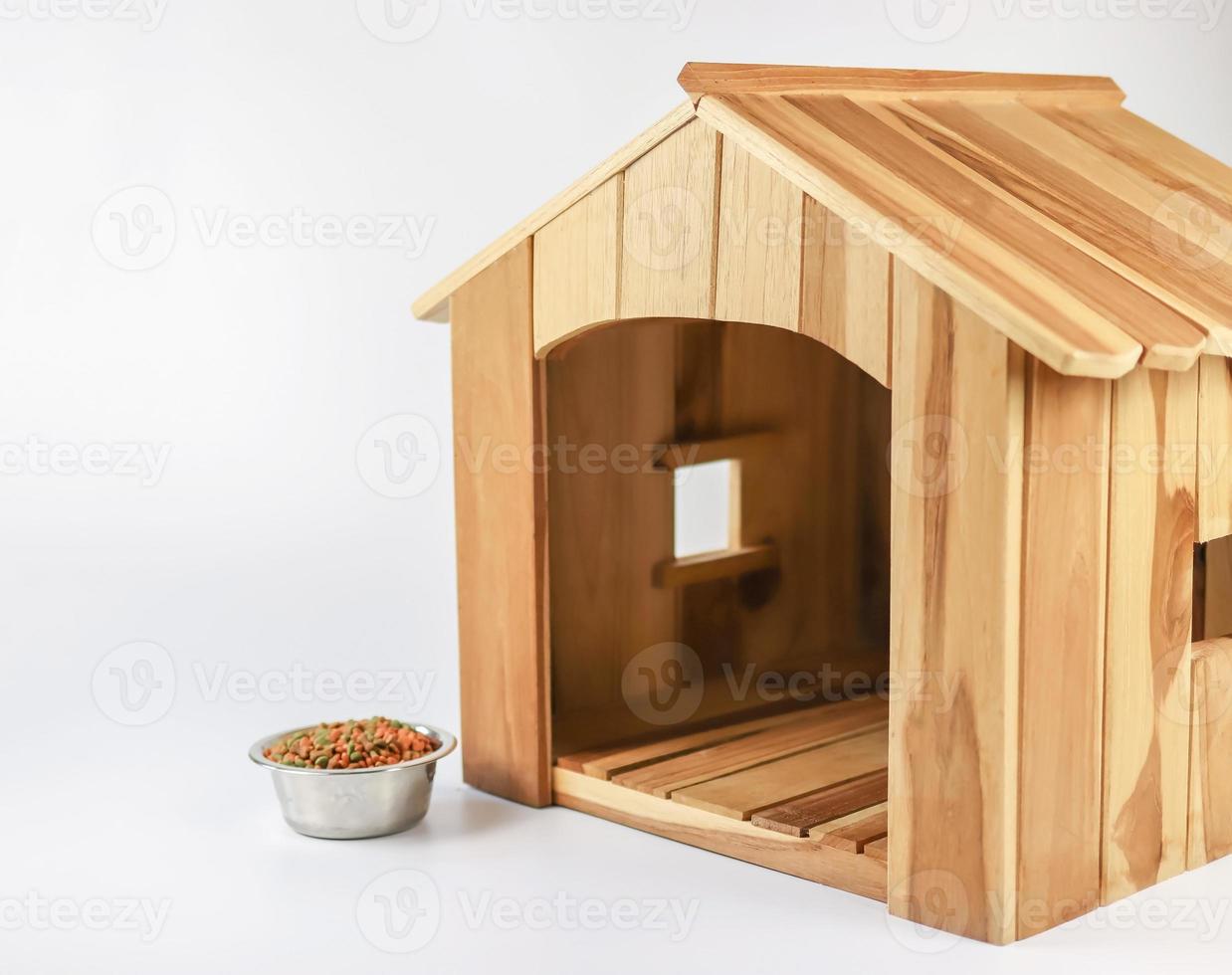 empty wooden dog's house with dog food bowl   on white background. Isolated. photo