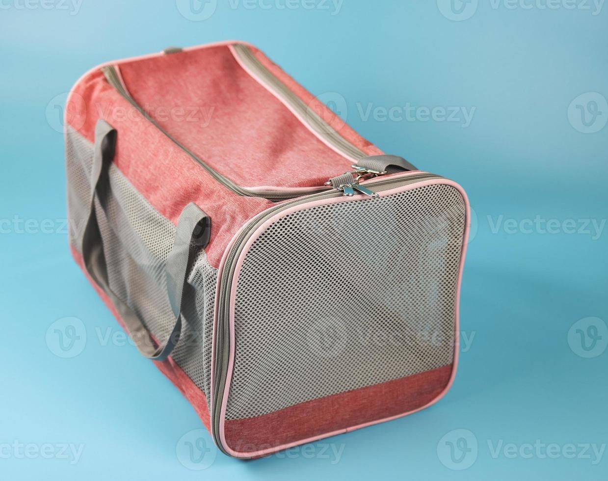 Animal transportation bag, isolated on blue background. photo