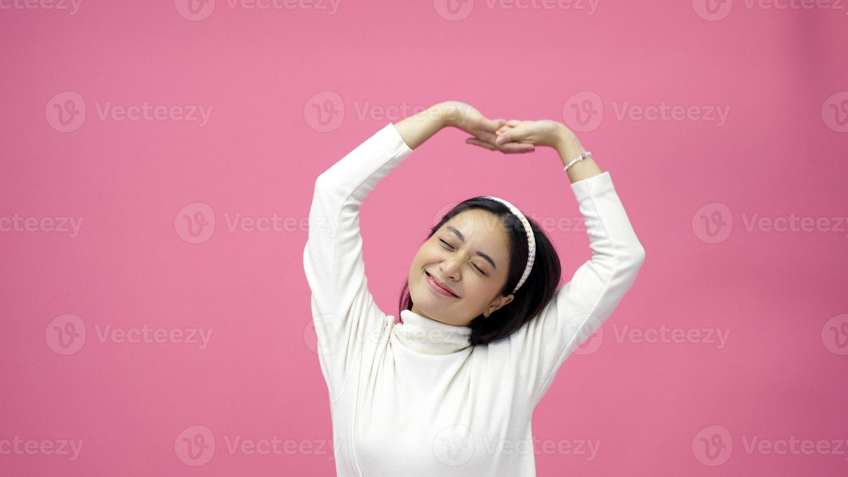 Asian women exercise and Sport woman Stretch on Morning, Preparing For Workout on pink background photo