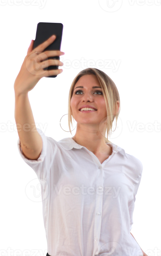 Portrait of a young attractive woman making selfie photo on smartphone in modern office building on transparent background png