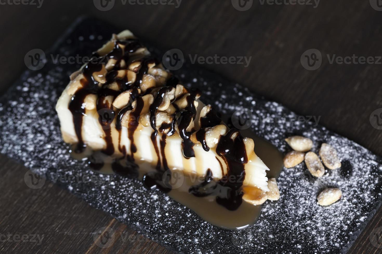 dessert cheesecake covered with caramel and chocolate photo